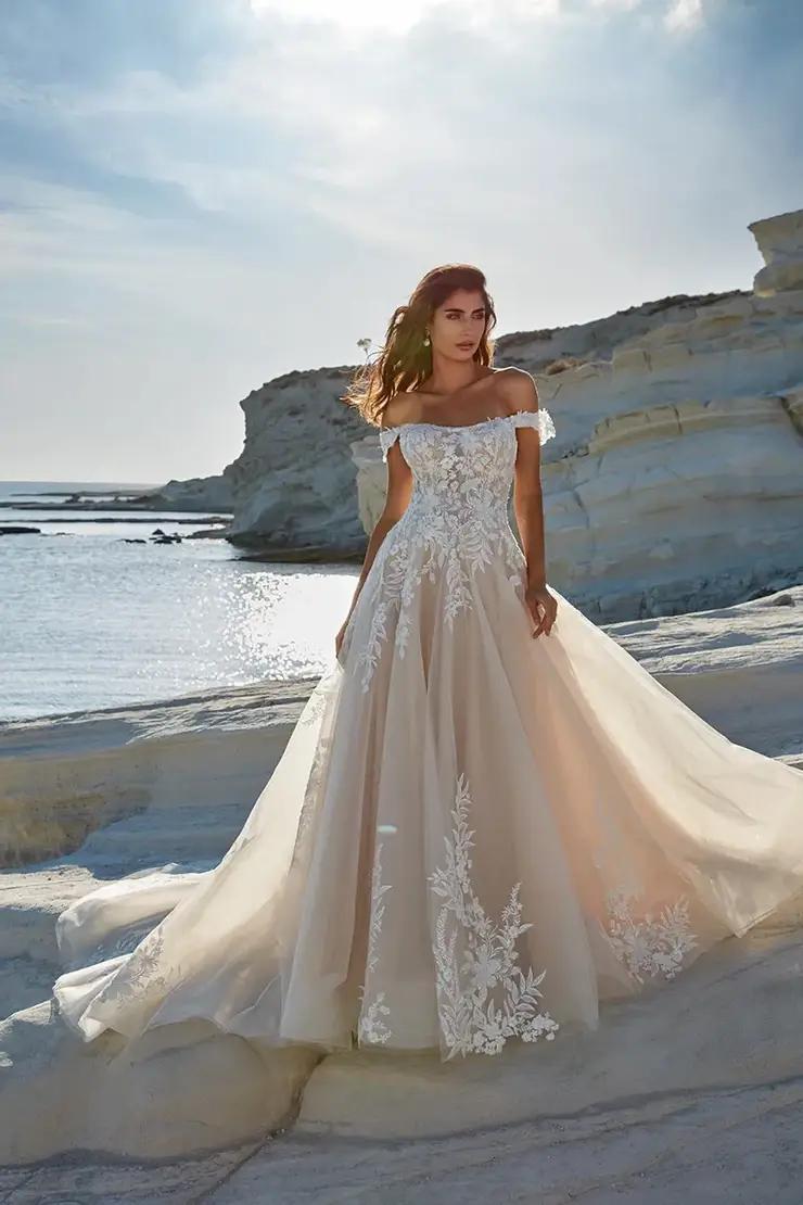 Model wearing a bridal gown on the beach