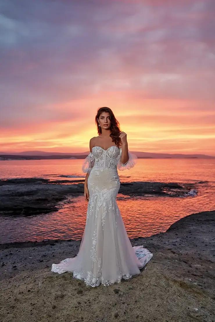 Model wearing a bridal gown at the beach