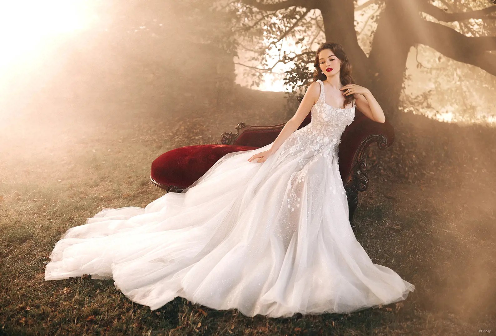 Blonde bride in white wedding dress near trees