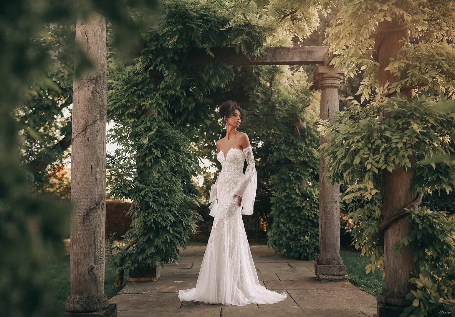 Bride in white wedding dress near ancient castle on the hill