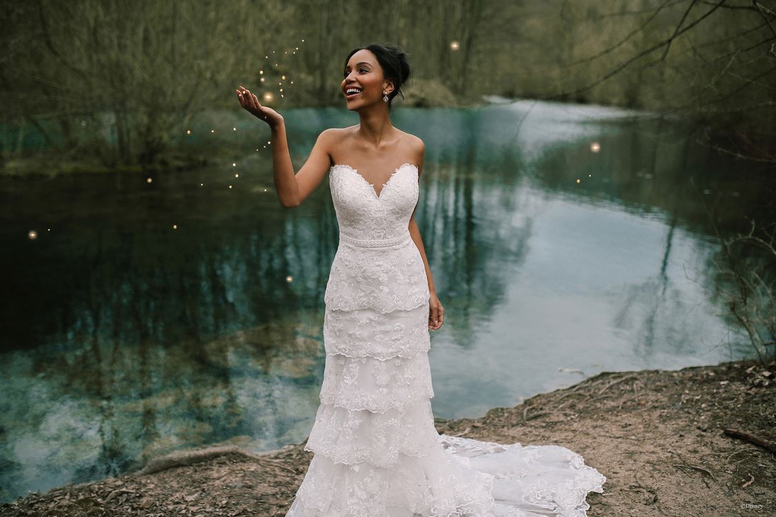 Brunette bride in white wedding dress near pond