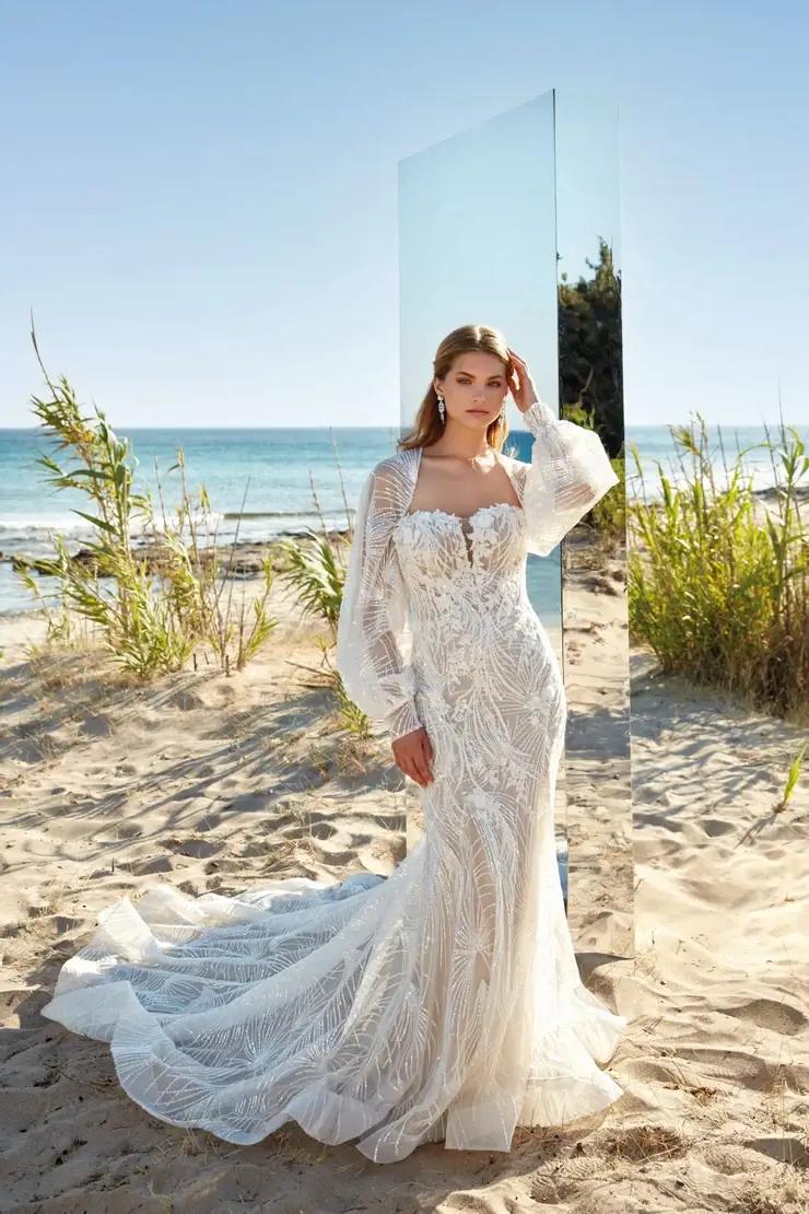 Model wearing a bridal gown on the beach