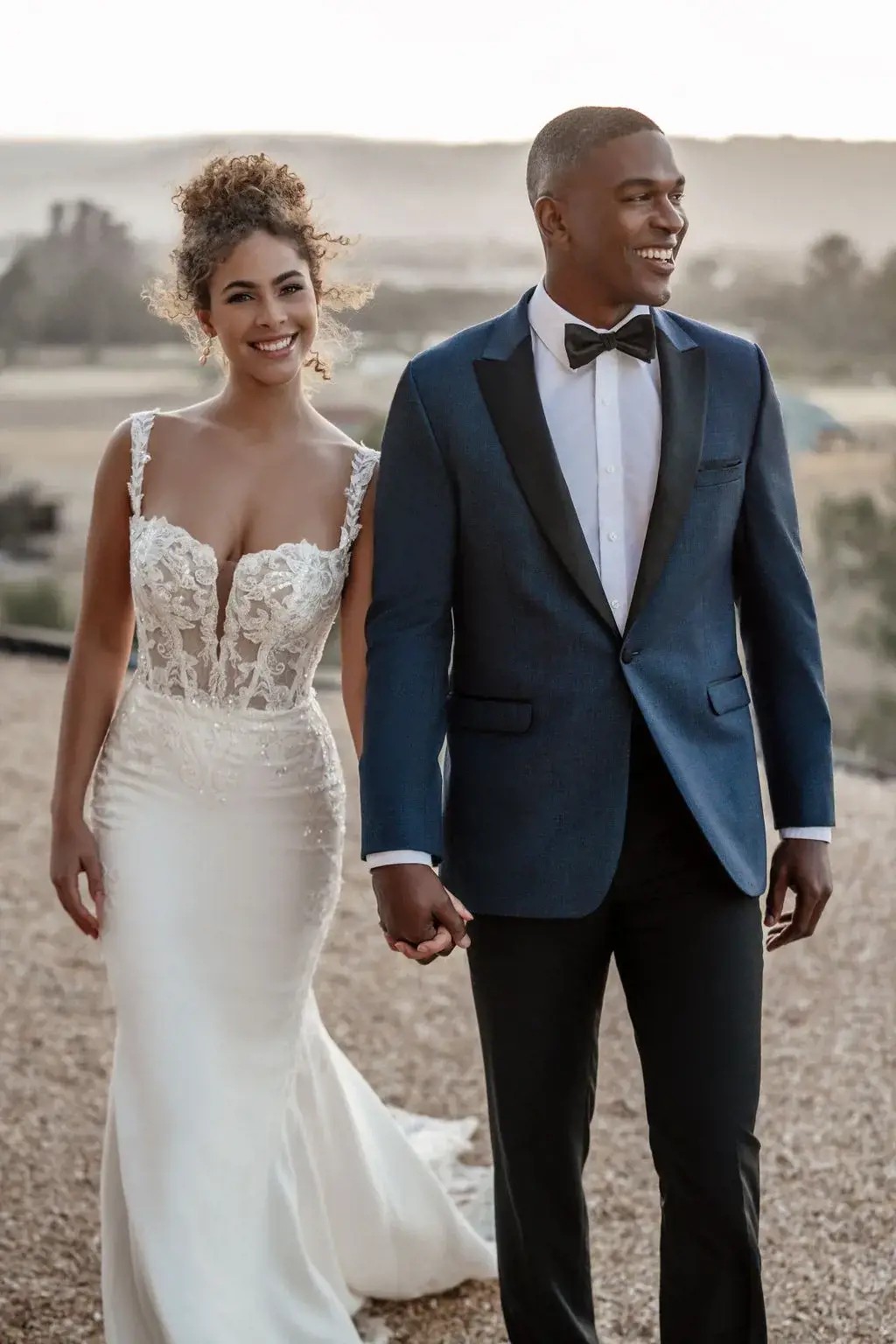 Сouple wearing a white gown and a black suit