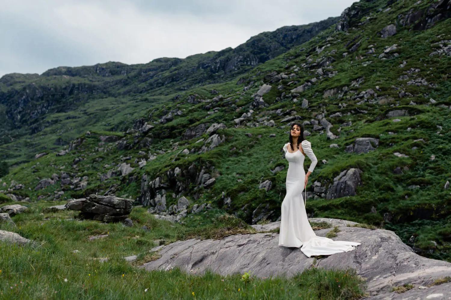 Model wearing a bridal dress in the mountains