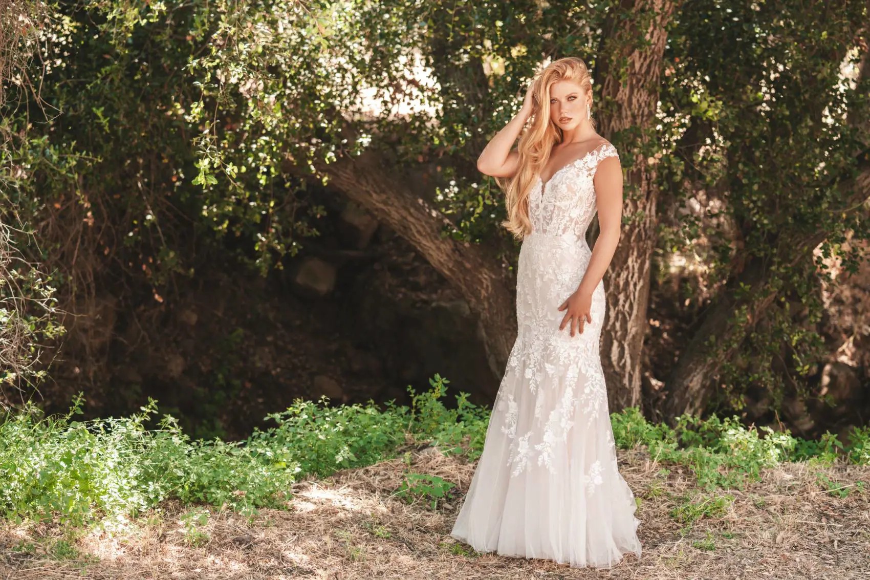 Model wearing a bridal gown under the tree