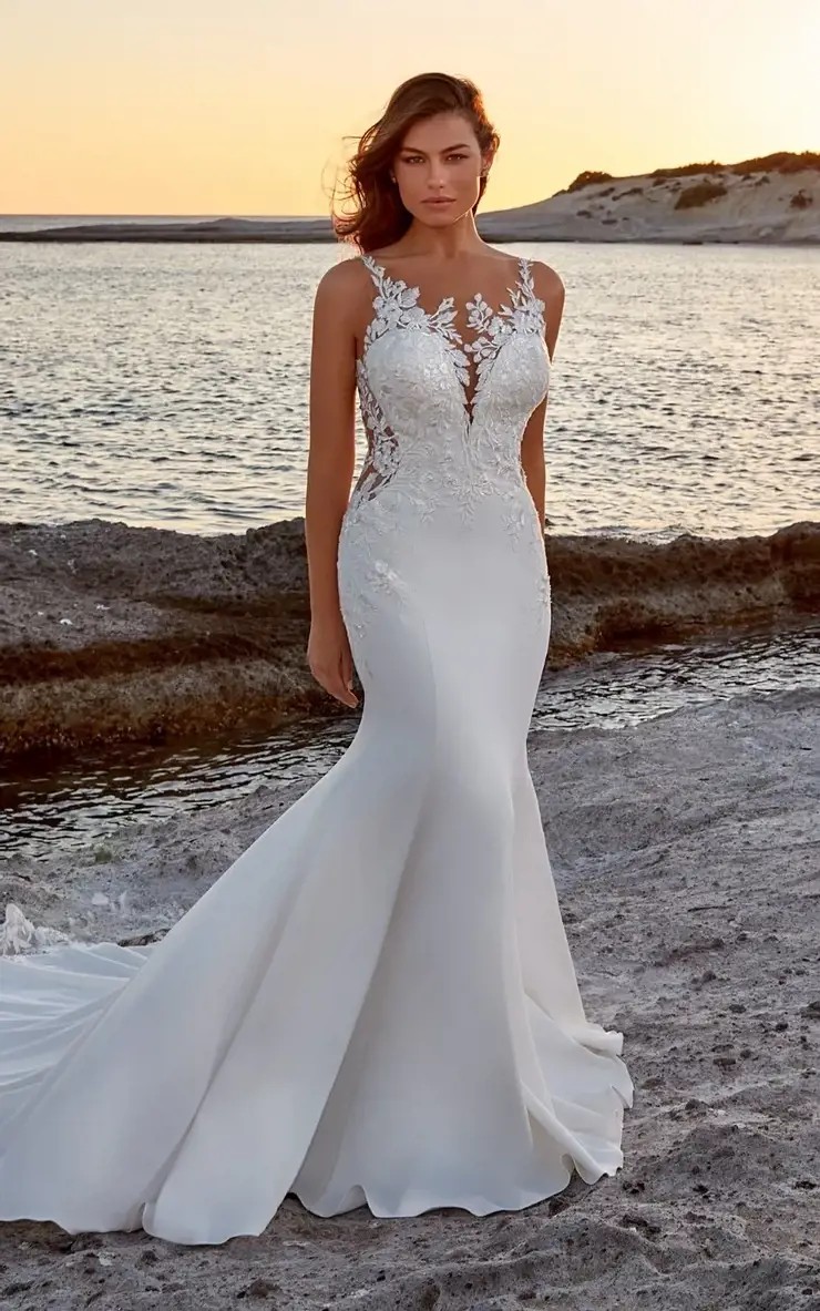 Model wearing a bridal gown at the beach